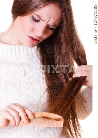 Woman combing and pulls hair. Woman combing and pulls hair. 127971585