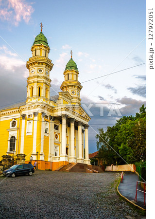uzhhorod, ukraine - 9 jul 2012: exterior of holy cross greek catholic cathedral on the hill in evening light. beautiful baroque style architecture. prominent religious landmark of europe 127972051