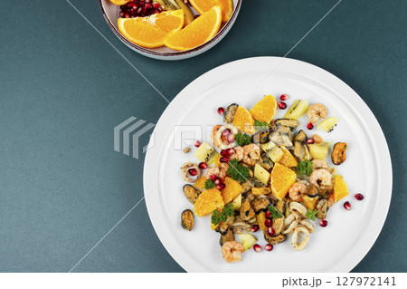 Plate of delicious fruit salad with seafood. 127972141