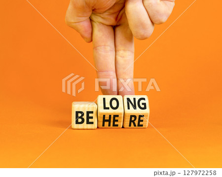 Belonging and belong symbol. Concept words Be here Belong on beautiful wooden block. Beautiful orange background Businessman hand. Business motivational belonging and belong concept. Copy space. Belonging and belong symbol. Concept words Be here Belong on beautiful wooden block. Beautiful orange background Businessman hand. Business motivational belonging and belong concept. Copy space. 127972258