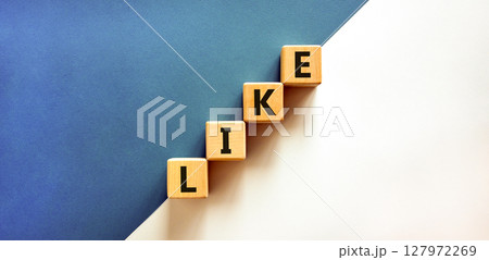 Like symbol. Concept word Like on beautiful wooden blocks. Beautiful white and blue background. Business, lifestyle, support and like concept. Copy space. Like symbol. Concept word Like on beautiful wooden blocks. Beautiful white and blue background. Business, lifestyle, support and like concept. Copy space. 127972269