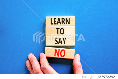 Learn to say no symbol. Concept words phrase Learn to say no on beautiful wooden blocks. Beautiful blue paper background. Businessman's hand. Business psychological Learn to say no concept Copy space Learn to say no symbol. Concept words phrase Learn to say no on beautiful wooden blocks. Beautiful blue paper background. Businessman's hand. Business psychological Learn to say no concept Copy space 127972292