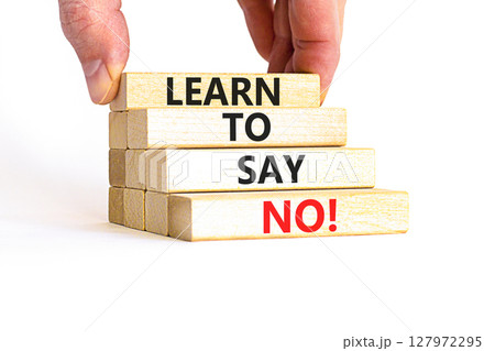 Learn to say no symbol. Concept words phrase Learn to say no on beautiful wooden blocks. Beautiful white paper background. Businessman's hand. Business psychological Learn to say no concept Copy space 127972295