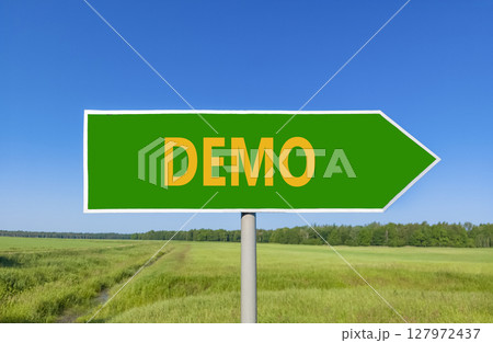 Demo symbol. Concept word Demo on beautiful green road sign. Beautiful blue sky green grass and forest peaceful nature background. Business and demo concept. Copy space. Demo symbol. Concept word Demo on beautiful green road sign. Beautiful blue sky green grass and forest peaceful nature background. Business and demo concept. Copy space. 127972437