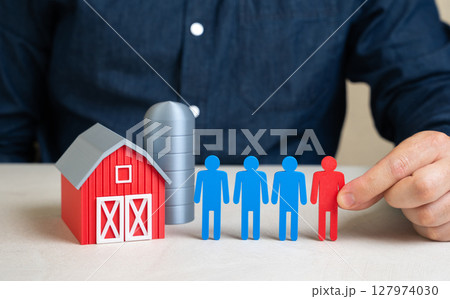 The man resolves the labor shortage in the agricultural sector. Workforce management in rural areas, hiring migrants, or promoting agri-robotics. Global food supply issues 127974030