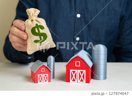 Man provides funds for expansion of farm. Investments in agricultural sector. Venture capital in agtech. Modernization of farming infrastructure, crop diversification, or farm equipment financing. 127974047