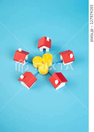 Houses are surrounded by money coins. Uniting households into neighborhood organizations and communities. Local development funding, homeowner associations. Real estate improvements. 127974165