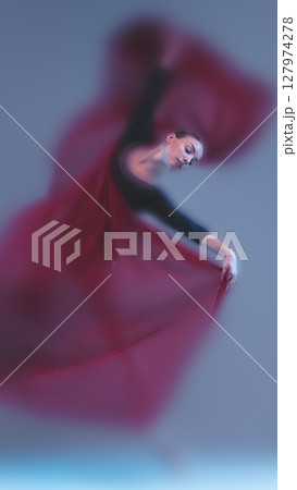 Crimson faded ballet flow with graceful movement and atmospheric tension 127974278