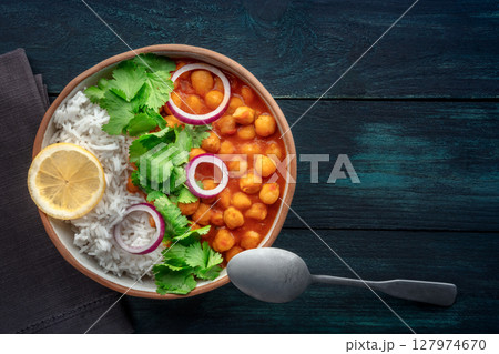 Chana masala, chickpea curry, traditional Indian dish, overhead flat lay shot Chana masala, chickpea curry, traditional Indian dish, overhead flat lay shot 127974670