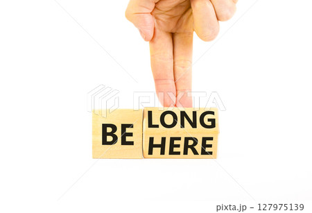 Belonging and belong symbol. Concept words Be here Belong on beautiful wooden block. Beautiful white background Businessman hand. Business motivational belonging and belong concept. Copy space. 127975139