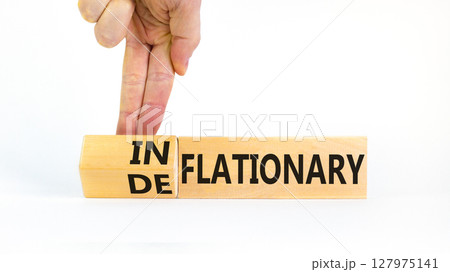 Deflationary or inflationary symbol. Concept words Deflationary Inflationary on wooden blocks. Beautiful white background. Businessman hand. Business deflationary inflationary concept. Copy space Deflationary or inflationary symbol. Concept words Deflationary Inflationary on wooden blocks. Beautiful white background. Businessman hand. Business deflationary inflationary concept. Copy space 127975141