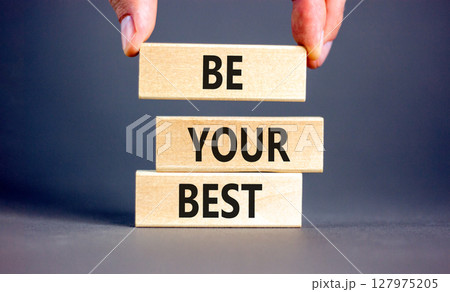 Motivational be your best symbol. Concept words Be your best on beautiful wooden blocks. Beautiful grey background. Businessman hand. Business motivational be your best concept. Copy space. 127975205
