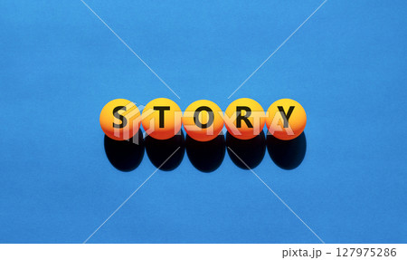 Story symbol. Concept word Story on beautiful yellow tennis ping pong balls. Beautiful wooden table wooden background. Business lifestyle story concept. Copy space. 127975286