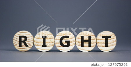 Right symbol. Concept word Right on beautiful wooden circles. Beautiful grey table grey background. Business lifestyle right concept. Copy space. 127975291