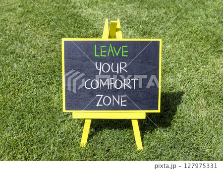 Leave your comfort zone symbol. Concept words Leave your comfort zone on beautiful blackboard. Beautiful green grass lawn background. Business psychological Leave your comfort zone concept. Copy space 127975331