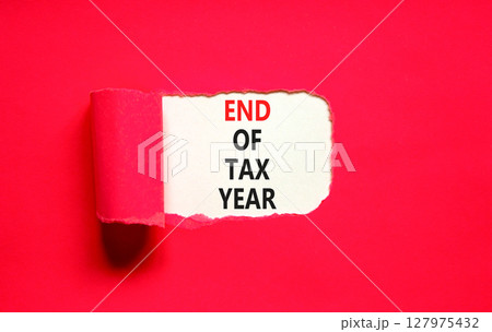 End of tax year symbol. Concept words phrase End of tax year on beautiful white paper. Beautiful red paper background. Business End of tax year concept. Copy space. 127975432