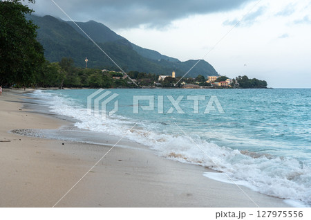 Anse Beau Vallon tropical beach in cloudy weather, ocean waves out of season on Mahe island Anse Beau Vallon tropical beach in cloudy weather, ocean waves out of season on Mahe island 127975556