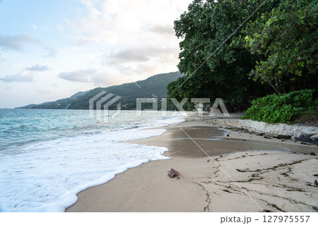 Anse Beau Vallon tropical beach in cloudy weather, ocean waves out of season on Mahe island Anse Beau Vallon tropical beach in cloudy weather, ocean waves out of season on Mahe island 127975557