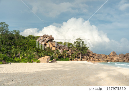 White sand beach meets granite boulders and tropical vegetation along the coast White sand beach meets granite boulders and tropical vegetation along the coast 127975830