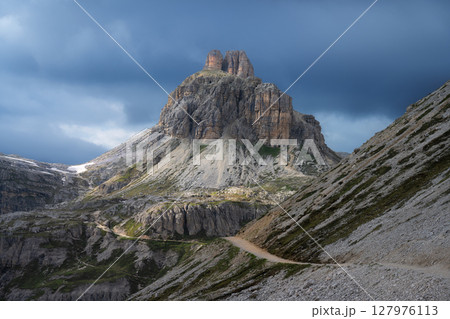 Tre Cime di Lavaredo mountains under dramatic cloudy sky 127976113