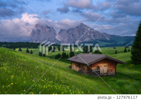 Idyllic mountain landscape with wooden house in mountain valley Idyllic mountain landscape with wooden house in mountain valley 127976117