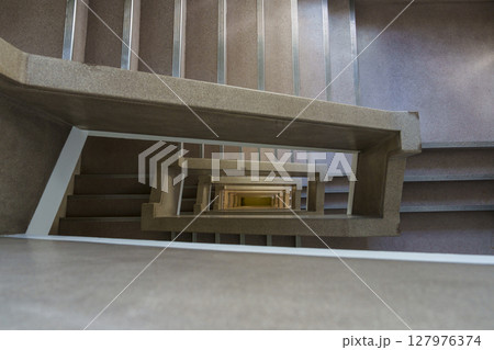 吹き抜け階段を真上から覗いた幾何学的な構造美 127976374
