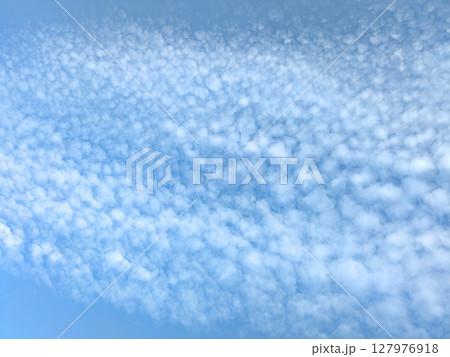 Pretty blue sky with bubble style white clouds floating atmosphere gentle skyscape 127976918