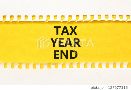 Tax year end symbol. Concept words Tax year end on beautiful yellow paper. Beautiful yellow white background. Business tax year end concept. Copy space. Tax year end symbol. Concept words Tax year end on beautiful yellow paper. Beautiful yellow white background. Business tax year end concept. Copy space. 127977316