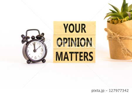 Your opinion matters symbol. Concept words Your opinion matters on beautiful wooden blocks. Beautiful white background. Black alarm clock. Business your opinion matters concept. Copy space. 127977342