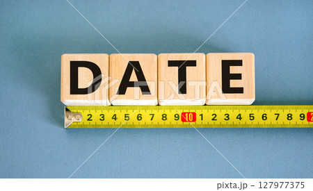 Date symbol. Concept word Date on beautiful wooden blocks. Beautiful yellow ruler. Beautiful blue table blue background. Business and date concept. Copy space. Date symbol. Concept word Date on beautiful wooden blocks. Beautiful yellow ruler. Beautiful blue table blue background. Business and date concept. Copy space. 127977375
