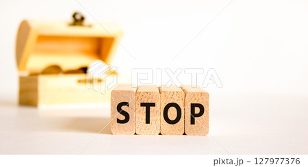 Stop symbol. Concept word Stop on beautiful wooden blocks. Beautiful wooden chest with coins. Beautiful white table white background. Business, lifestyle, support and stop concept. Copy space. 127977376