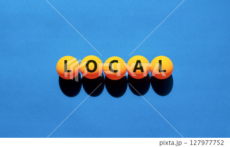 Local symbol. Concept word Local on beautiful yellow tennis ping pong balls. Beautiful wooden table wooden background. Business lifestyle local concept. Copy space. Local symbol. Concept word Local on beautiful yellow tennis ping pong balls. Beautiful wooden table wooden background. Business lifestyle local concept. Copy space. 127977752