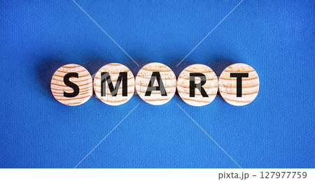 Smart symbol. Concept word Smart on beautiful wooden circles. Beautiful blue table blue background. Business lifestyle smart concept. Copy space. Smart symbol. Concept word Smart on beautiful wooden circles. Beautiful blue table blue background. Business lifestyle smart concept. Copy space. 127977759