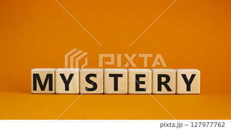Mystery symbol. The concept word Mystery on wooden cubes. Beautiful orange table, orange background, copy space. Business and mystery mysterious concept. Mystery symbol. The concept word Mystery on wooden cubes. Beautiful orange table, orange background, copy space. Business and mystery mysterious concept. 127977762