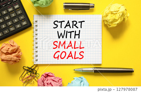 Start with small goals symbol. Concept words phrase Start with small goals on beautiful white note. Colored paper. Beautiful yellow background. Business Start with small goals concept. Copy space Start with small goals symbol. Concept words phrase Start with small goals on beautiful white note. Colored paper. Beautiful yellow background. Business Start with small goals concept. Copy space 127978087