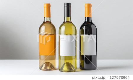 Three wine bottles stand side-by-side, showcasing red, white, and rose varieties, perfect for a tasting or special occasion. Cheers! 127978964