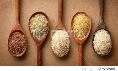 Varieties of Rice in Wooden Spoons. A display of rice from different types to present the grains in their natural setting. An array of natural rice. 127978966