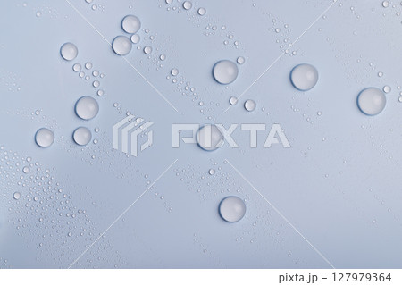 a smooth surface of light blue color covered with water droplets, a beautiful wet blue film in a large number of water drops a smooth surface of light blue color covered with water droplets, a beautiful wet blue film in a large number of water drops 127979364