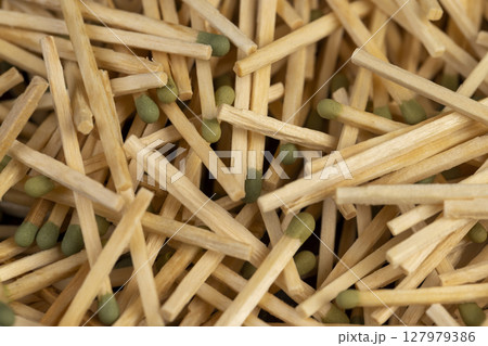 matches scattered in a large pile, scattered wooden matches without matchboxes on the table, closeup matches scattered in a large pile, scattered wooden matches without matchboxes on the table, closeup 127979386