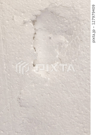 white foam for building insulation close up, white foam made from a large number of spherical pieces joined together, dents and damages in the foam white foam for building insulation close up, white foam made from a large number of spherical pieces joined together, dents and damages in the foam 127979409
