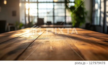 warm wooden table in sunlit office 127979478