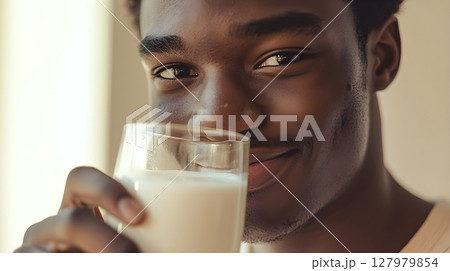man enjoying a glass of milk 127979854