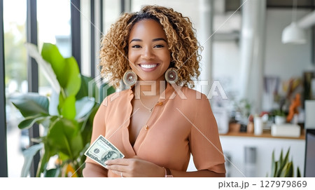 happy woman holding money in office 127979869