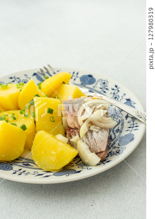 Boiled potatoes with pickled herring and sauerkraut Boiled potatoes with pickled herring and sauerkraut 127980319