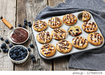 tasty blueberry muffins with lemon chocolate glaze tasty blueberry muffins with lemon chocolate glaze 127980334