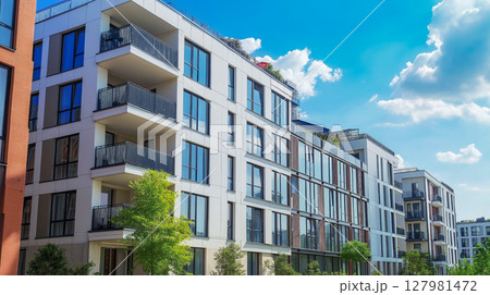 Modern apartment building with large windows and balconies 127981472