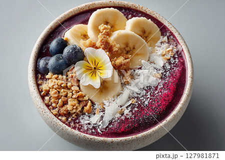 Vegetarian smoothie with coconut milk.  Acai bowl with granola and edible flowers. Hotel Breakfast Styles. 127981871