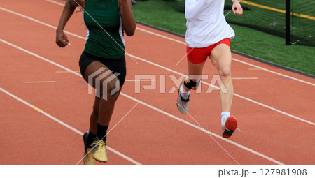 Runners Competing on a Track During a School Athletics Event Runners Competing on a Track During a School Athletics Event 127981908