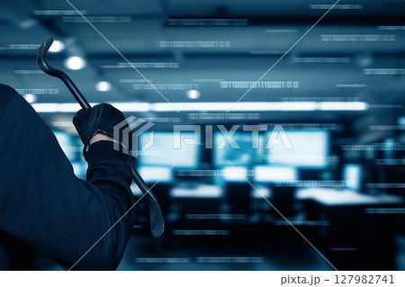 Intruder with a crowbar in a dark office space 127982741