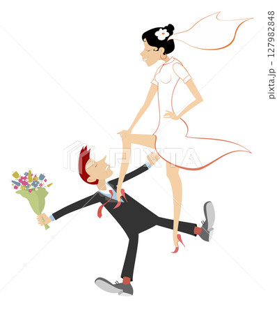 Arguing married wedding couple. The end of bachelor life. An angry bride puts her foot on a chest of a lying bridegroom with a bunch of flowers 127982848